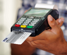 Debit card inserted in merchant machine photo